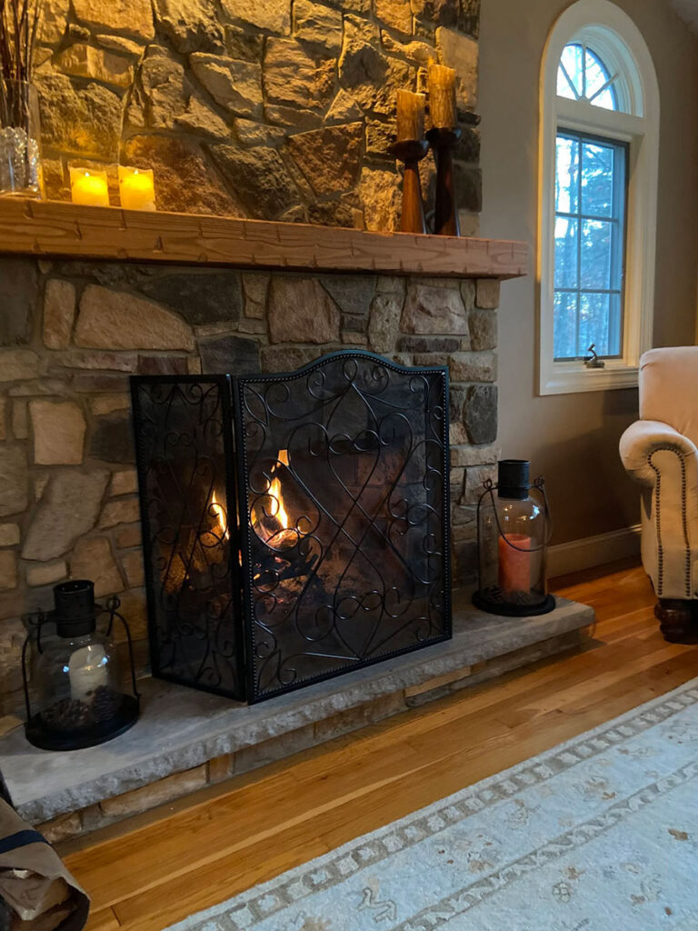 Close view of manufactured fieldstone veneer surrounding a working fireplace