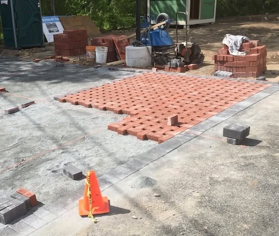 Unilock permeable pavers being installed in a basketweave pattern in Weymouth, MA