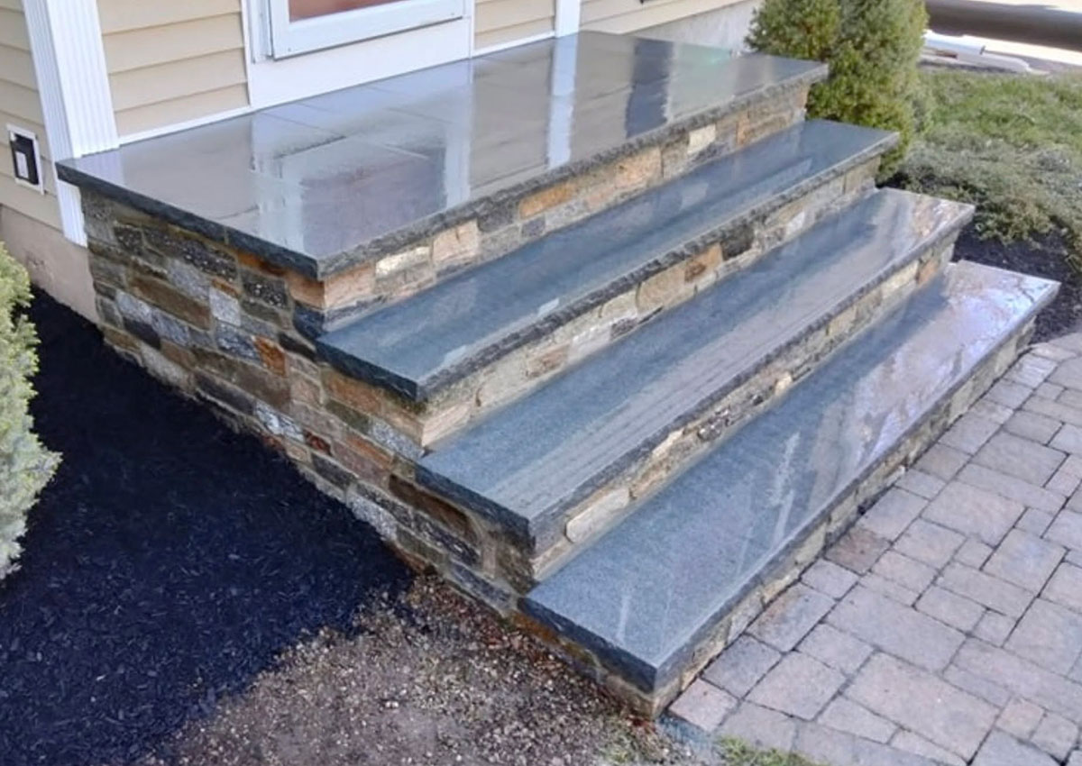 Side view of completed granite and ledgestone front steps at a Mansfield home