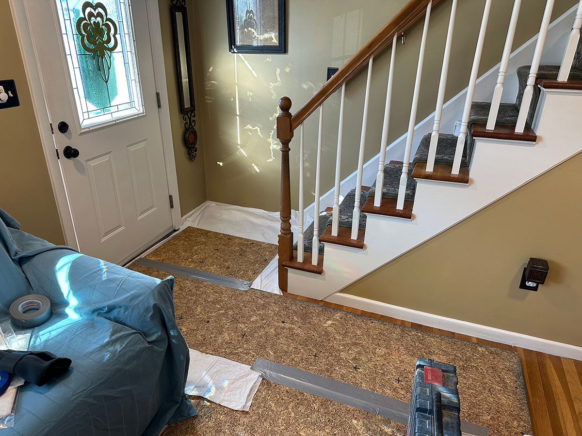 Protective floor panels laid from the entry to the fireplace work area