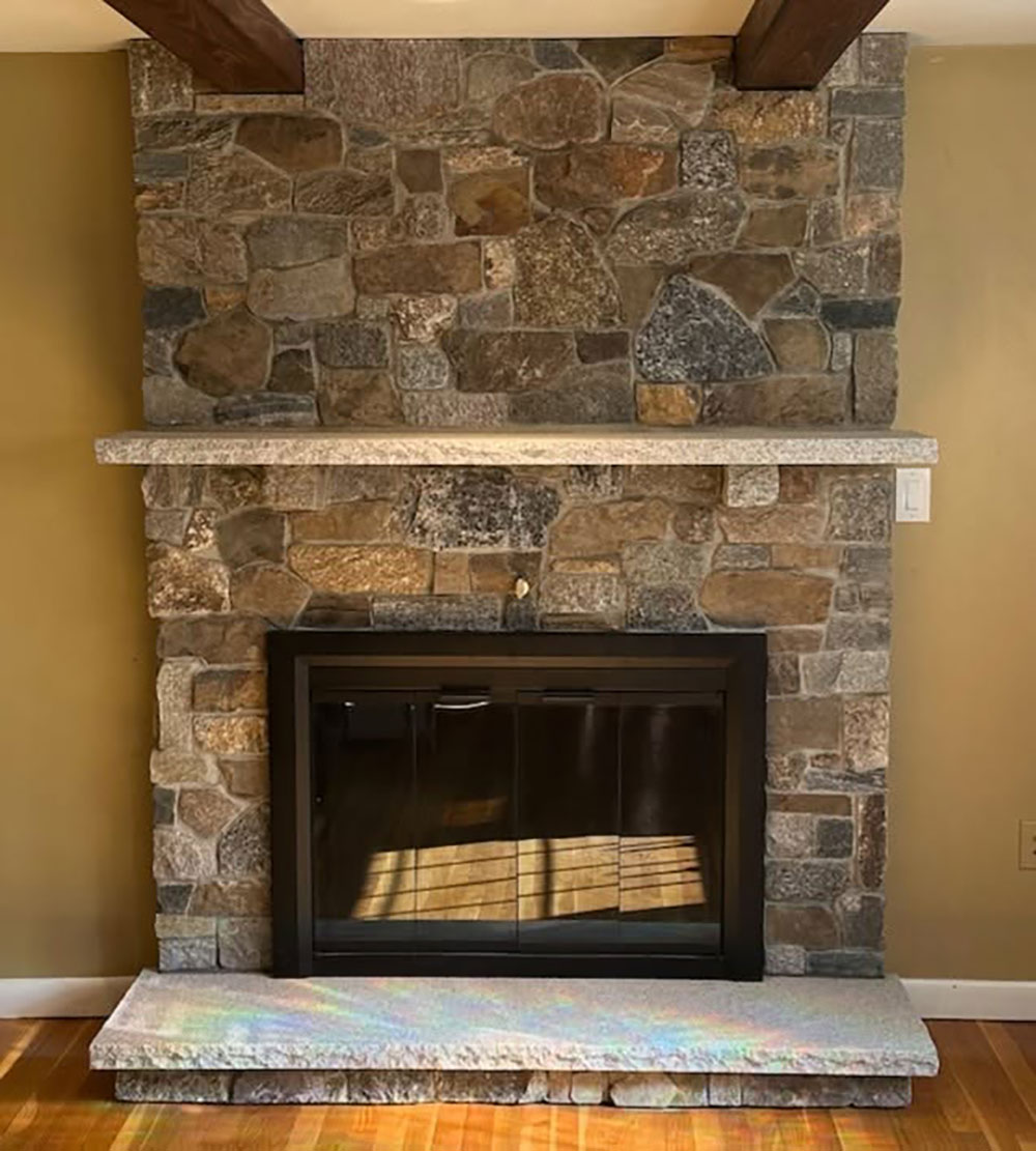 Lexington Blend stone veneer fireplace with custom granite details in Raynham, MA