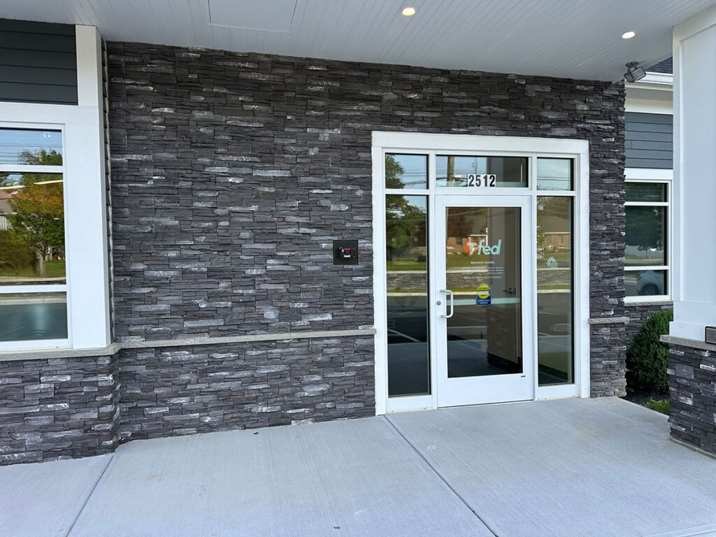 Dark Rundle stone veneer surrounding the entrance at Taunton Federal Credit Union