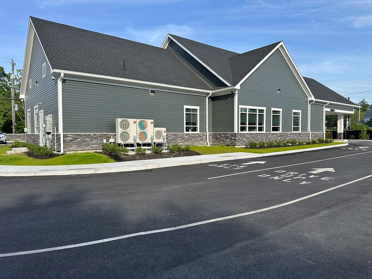 Stone veneer extending around the side and rear of the commercial credit union building