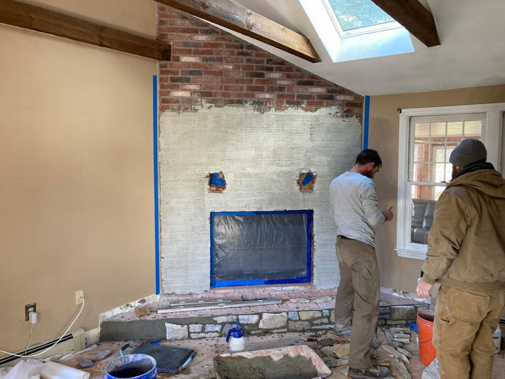 Thin stone veneer installation in progress on an interior fireplace in Pembroke, MA