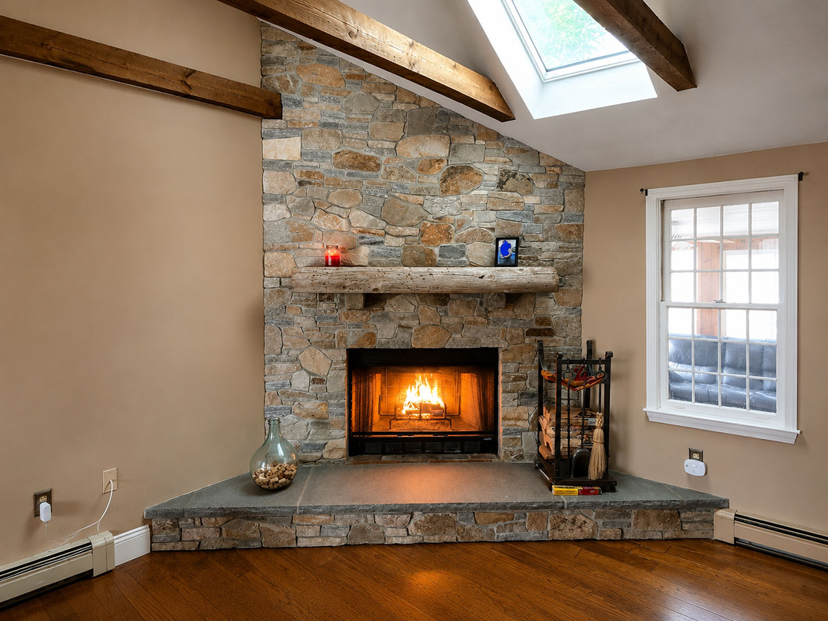 Finished thin stone veneer fireplace with bluestone hearth and reclaimed driftwood mantel