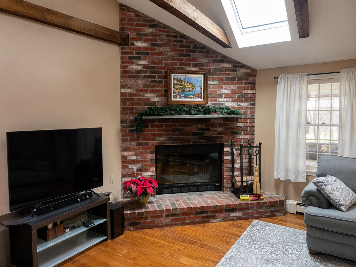 Original brick fireplace before stone veneer refacing in Pembroke, MA