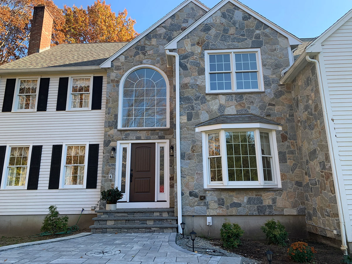 Completed residential exterior stone veneer facade in Mansfield, Massachusetts