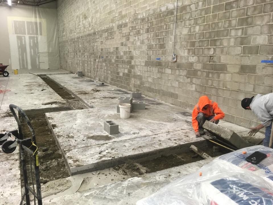 experienced commercial masons cutting concrete
