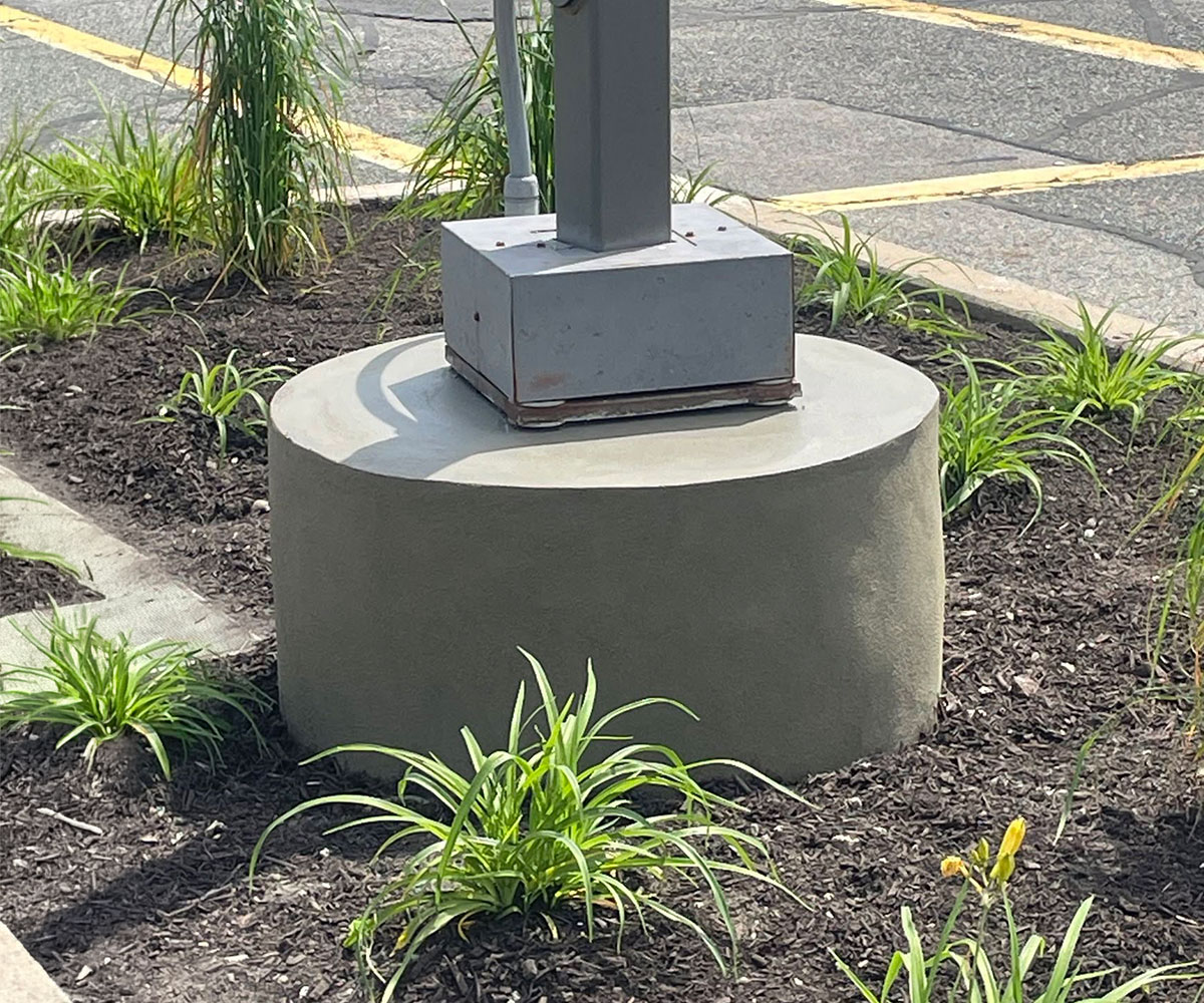 Completed commercial light pole base repair in Marlborough, Massachusetts