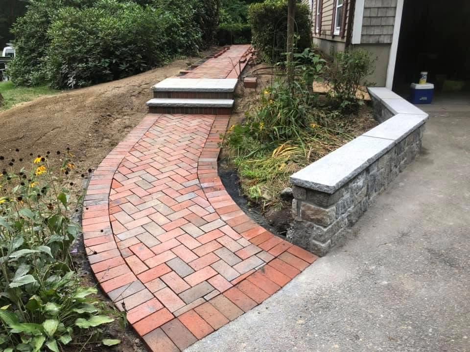 brick walkway with granite steps and a block retaining wall