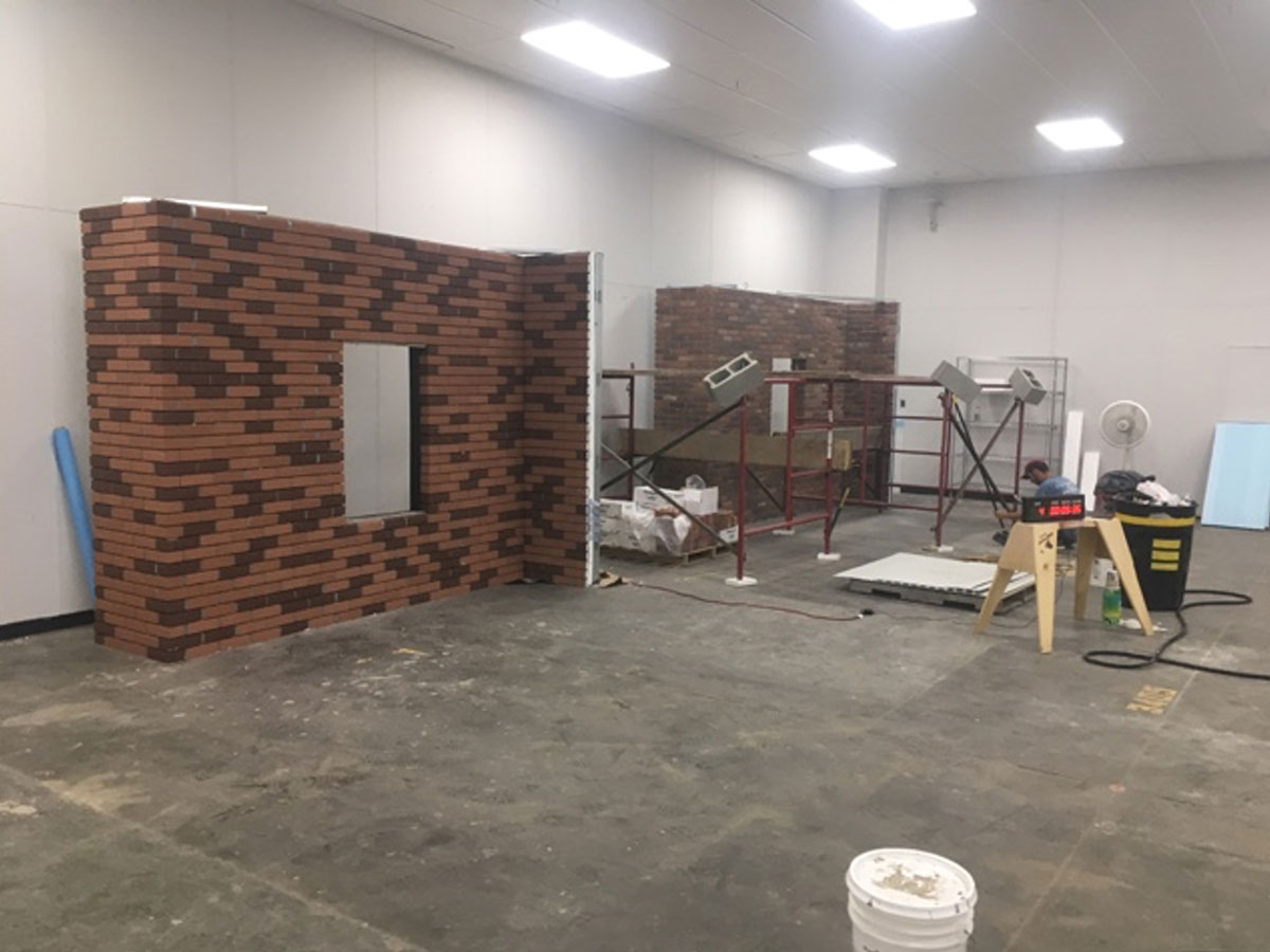 Completed Dryvit NewBrick demonstration walls with varied brick patterns at the Rhode Island facility.