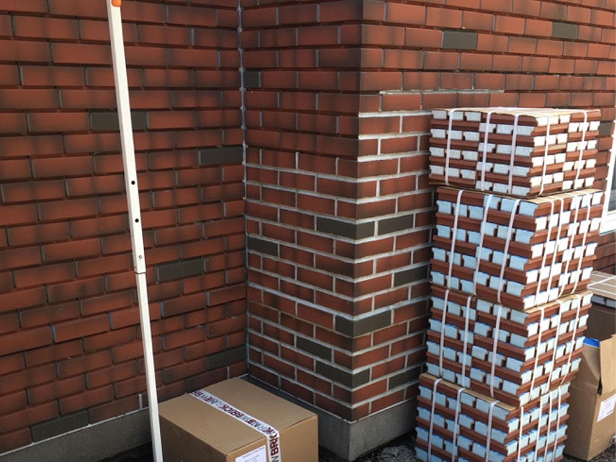 Close-up of a Dryvit NewBrick corner showing blended brick colors and finished mortar joints.